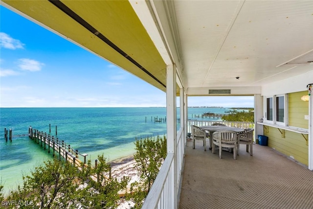 exterior space featuring a beach view and a water view