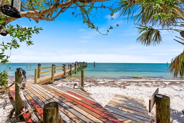 exterior space featuring a dock and a view of the beach