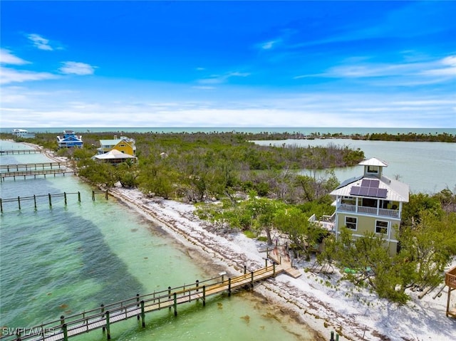 birds eye view of property with a beach view and a water view