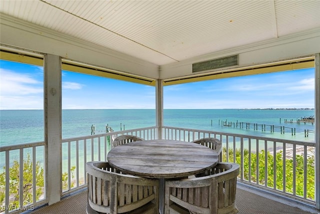 sunroom / solarium featuring a water view