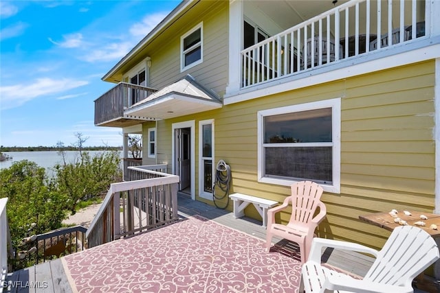wooden terrace featuring a water view