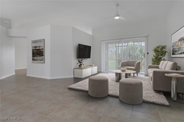 3340 33rd Ave NE, Naples, FL 34120 - living area with a towering ceiling, a ceiling fan, baseboards, and light tile patterned floors