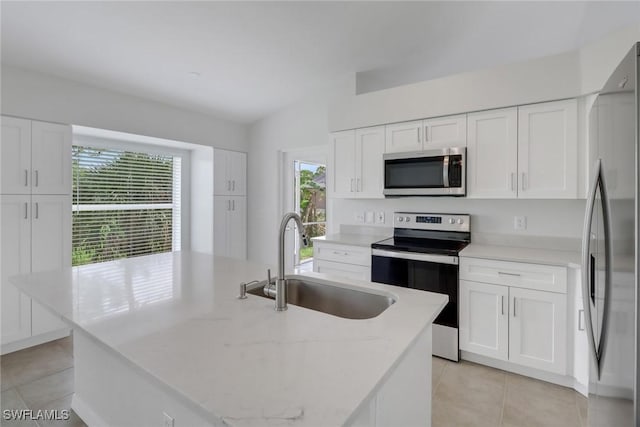 3340 33rd Ave NE, Naples, FL 34120 - kitchen featuring stainless steel appliances, a sink, white cabinetry, and light tile patterned floors