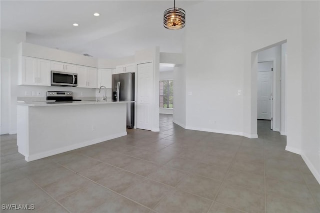 3340 33rd Ave NE, Naples, FL 34120 - kitchen featuring white cabinets, stainless steel appliances, a sink, light countertops, and light tile patterned floors