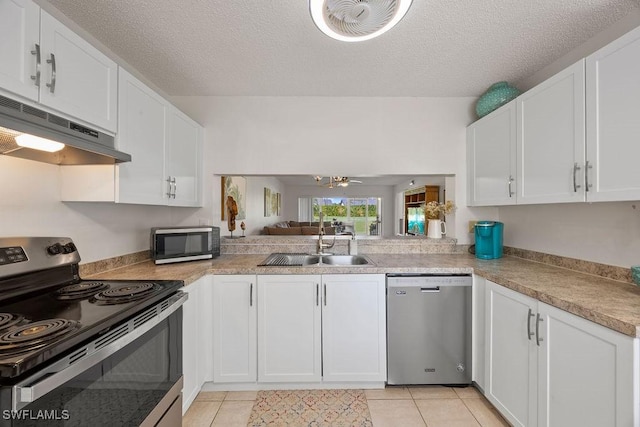 3705 Amberly Cir Unit F102, Naples, FL 34112 - kitchen featuring stainless steel appliances, under cabinet range hood, a sink, white cabinets, and light tile patterned floors