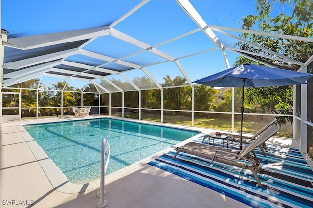 outdoor pool featuring a lanai and a patio area