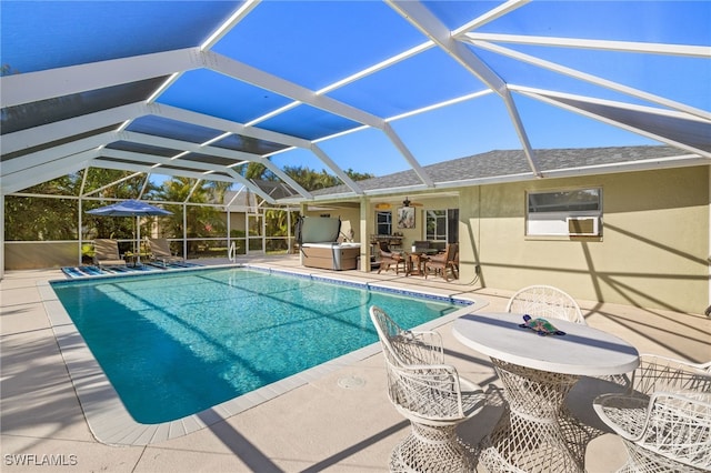 outdoor pool featuring glass enclosure, ceiling fan, outdoor dining space, and a patio area