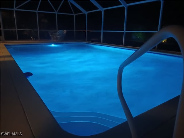 pool with a water slide and glass enclosure