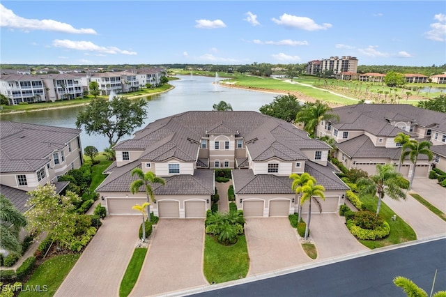 drone / aerial view with a water view and a residential view