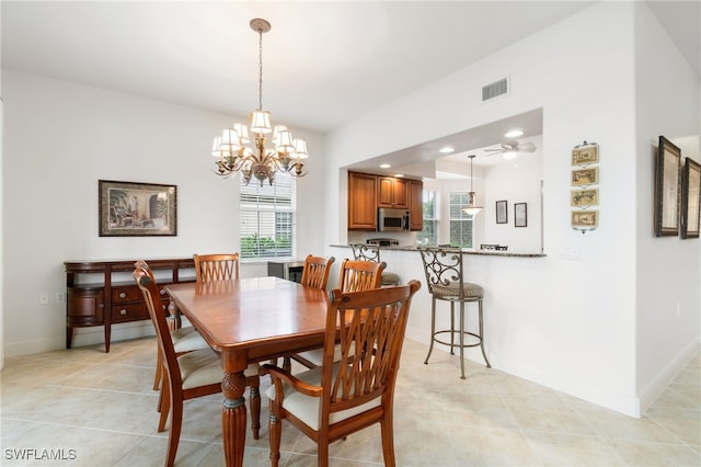 dining room featuring visible vents, baseboards, light tile patterned floors, and a notable chandelier