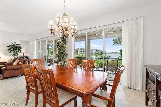dining room with light tile patterned floors, a water view, and a notable chandelier