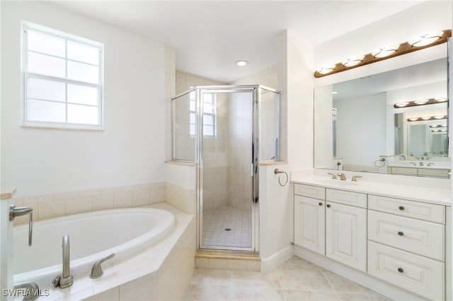 bathroom featuring vanity, tile patterned flooring, a shower stall, and a garden tub