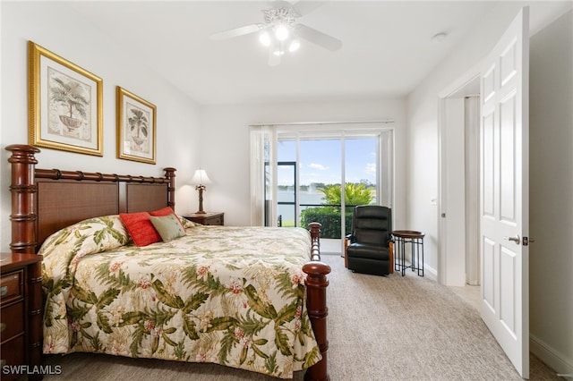 carpeted bedroom with baseboards, access to outside, a water view, and ceiling fan