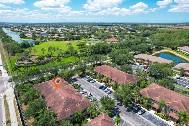 aerial perspective of suburban area with a nearby body of water