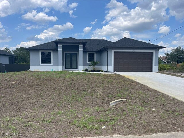 2710 10th St SW, Lehigh Acres, FL 33976 - view of front of property featuring stucco siding, an attached garage, concrete driveway, and roof with shingles