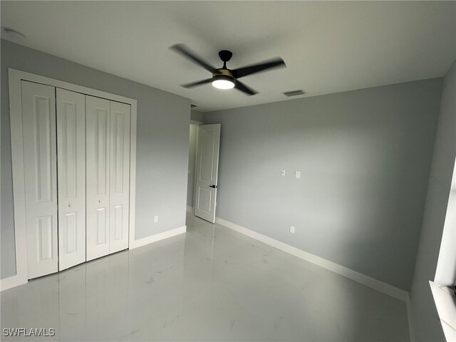2710 10th St SW, Lehigh Acres, FL 33976 - unfurnished bedroom featuring a closet, baseboards, and ceiling fan