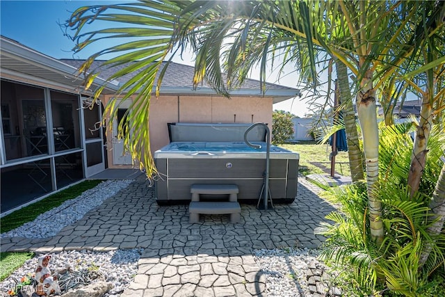 view of patio / terrace featuring fence and a hot tub