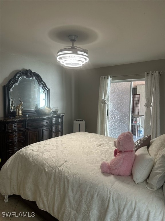 tiled bedroom featuring ceiling fan and access to outside