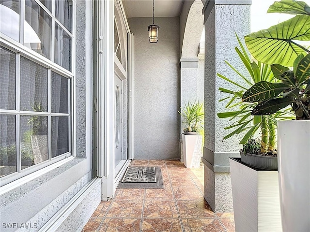 view of exterior entry featuring stucco siding