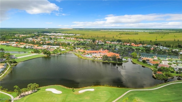 aerial view with view of golf course, a water view, and a residential view