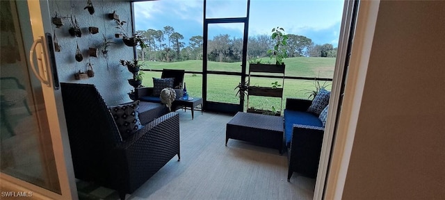 sunroom / solarium with plenty of natural light and view of golf course