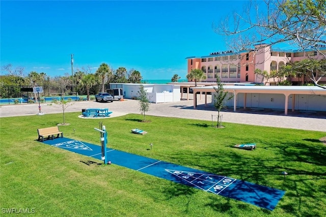 2230 Camino Del Mar Dr Unit 1C4, Sanibel, FL 33957 - view of home's community with fence, a yard, and shuffleboard