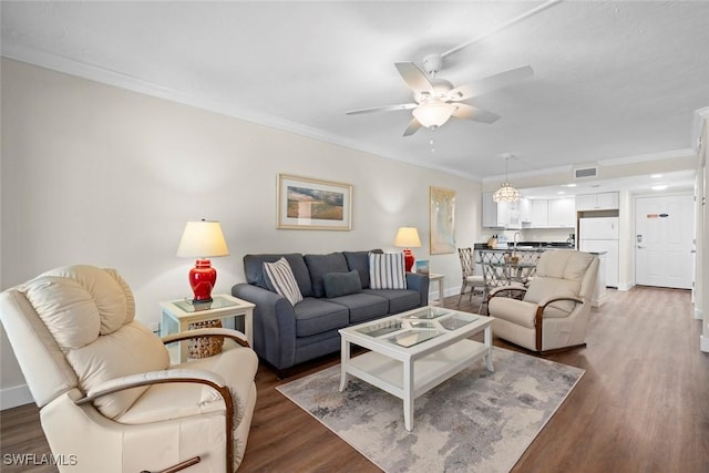 2230 Camino Del Mar Dr Unit 1C4, Sanibel, FL 33957 - living room with wood finished floors, visible vents, a ceiling fan, ornamental molding, and baseboards
