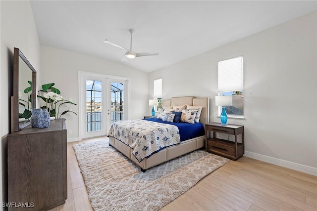 bedroom with access to exterior, french doors, baseboards, wood finished floors, and vaulted ceiling