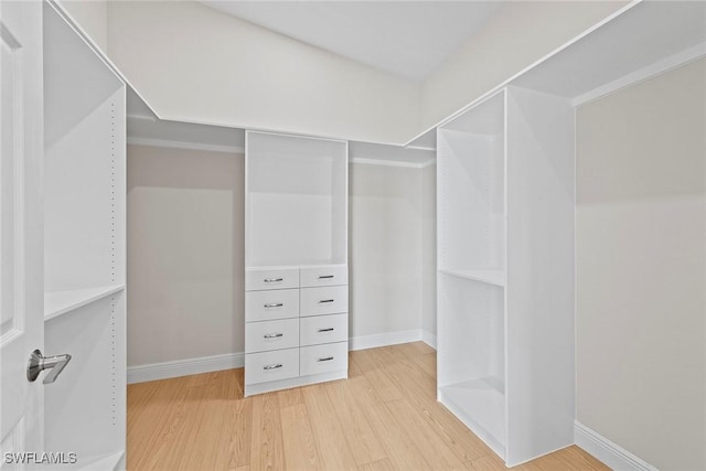 walk in closet featuring light wood finished floors