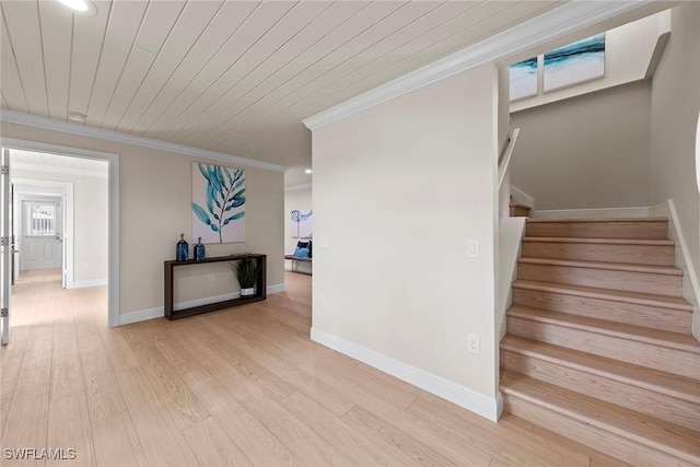 stairs with crown molding, wood finished floors, baseboards, and recessed lighting