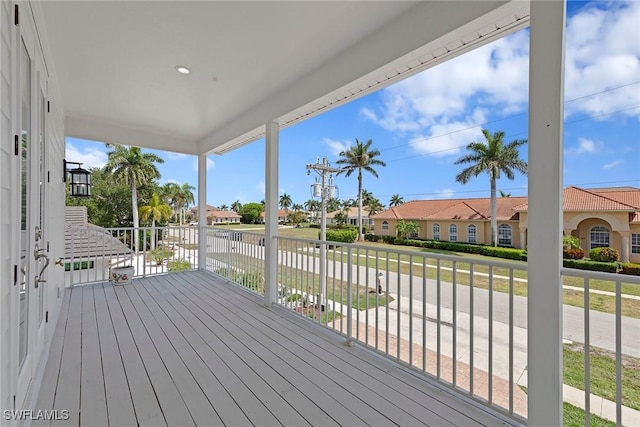 wooden terrace with a residential view