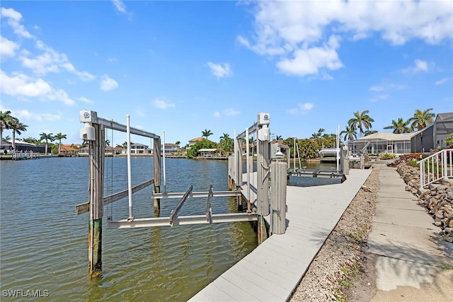 dock area with boat lift and a water view