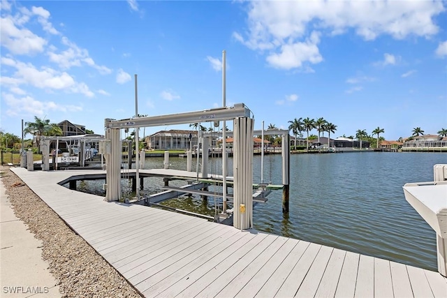 dock with boat lift and a water view