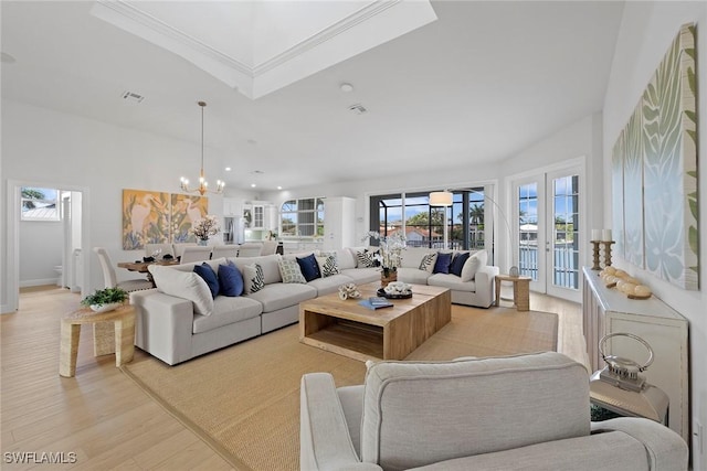 living room featuring a chandelier, light wood-style flooring, crown molding, and recessed lighting