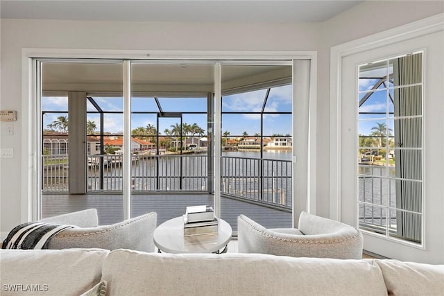 sunroom featuring a water view