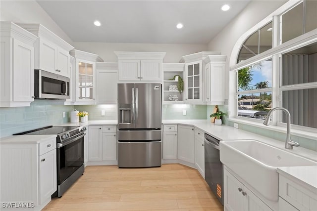 kitchen with stainless steel appliances, open shelves, a sink, white cabinetry, and recessed lighting