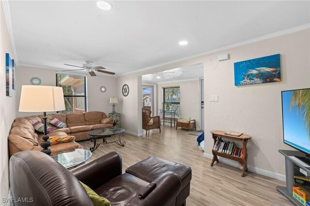 210 Miramar St, Fort Myers Beach, FL 33931 - living room with baseboards, light wood-type flooring, ornamental molding, and a healthy amount of sunlight