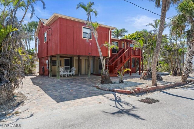 210 Miramar St, Fort Myers Beach, FL 33931 - exterior space with stairway, a carport, and driveway