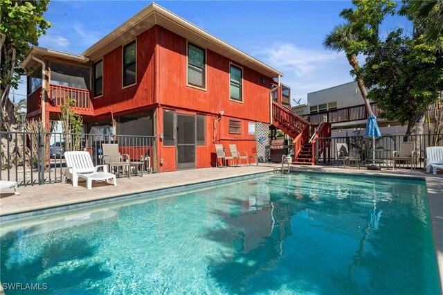 210 Miramar St, Fort Myers Beach, FL 33931 - view of swimming pool featuring a patio, fence, a fenced in pool, and stairs