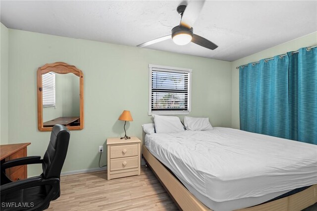 210 Miramar St, Fort Myers Beach, FL 33931 - bedroom with ceiling fan, baseboards, and light wood-style floors