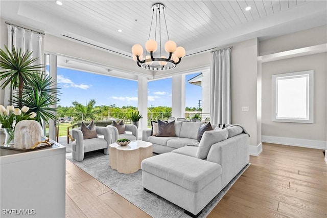 201 8th St S Unit 301, Naples, FL 34102 - living area with light wood finished floors, an inviting chandelier, baseboards, and recessed lighting