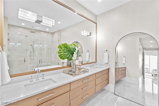201 8th St S Unit 301, Naples, FL 34102 - bathroom featuring a shower stall, recessed lighting, double vanity, and a sink