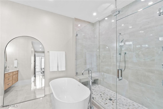 201 8th St S Unit 301, Naples, FL 34102 - full bath featuring a freestanding bath, baseboards, a shower stall, vanity, and recessed lighting