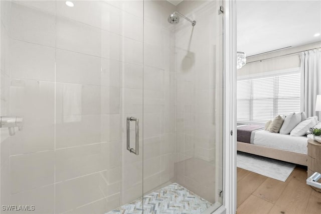 201 8th St S Unit 301, Naples, FL 34102 - bathroom with a shower stall, connected bathroom, and wood finished floors