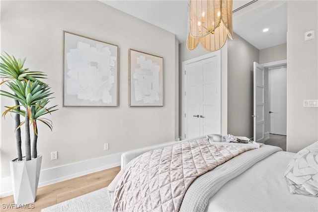 201 8th St S Unit 301, Naples, FL 34102 - bedroom with recessed lighting, baseboards, and light wood-style floors