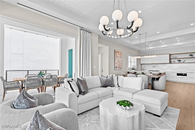 201 8th St S Unit 301, Naples, FL 34102 - living room with a raised ceiling, a notable chandelier, light wood finished floors, and recessed lighting