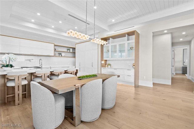 201 8th St S Unit 301, Naples, FL 34102 - dining room with light wood finished floors, indoor bar, baseboards, and recessed lighting