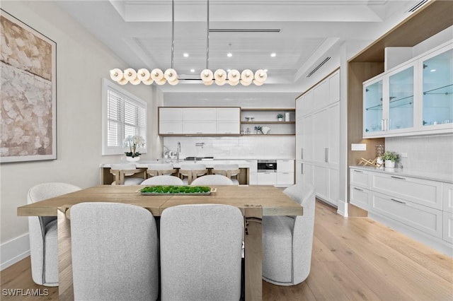 201 8th St S Unit 301, Naples, FL 34102 - dining space featuring baseboards, light wood-style flooring, a raised ceiling, and recessed lighting