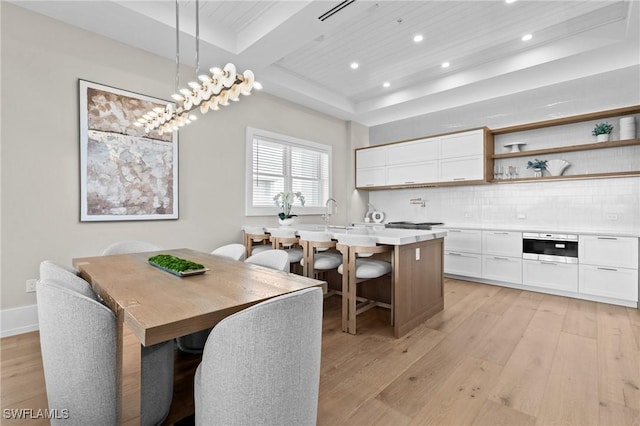 201 8th St S Unit 301, Naples, FL 34102 - dining space featuring wood ceiling, baseboards, a raised ceiling, light wood-style floors, and recessed lighting