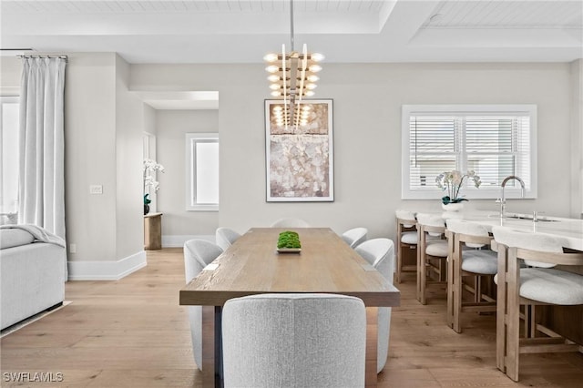 201 8th St S Unit 301, Naples, FL 34102 - dining area with light wood finished floors, beamed ceiling, baseboards, and a notable chandelier